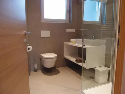 a bathroom with a toilet and a sink at Ausserdorfer Apartments in Lana