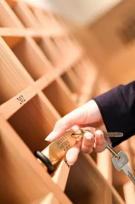 a person is holding a pair of scissors at Hotel Heide Park in Ora/Auer