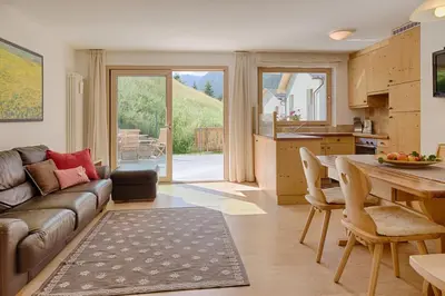 a living room with a couch and a table at Cademia in Ortisei