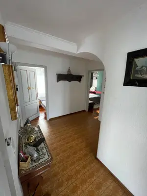 a living room with a hallway with a table and a door at Casa da Rina in Siror