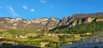a view of a mountain range with houses and trees at Voldersberghof in Cortaccia