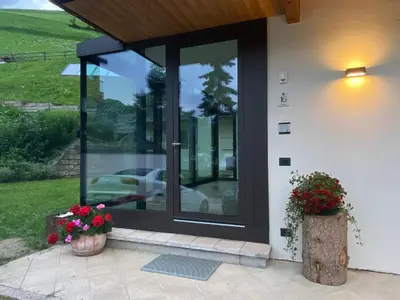 a front door of a house with flowers on the porch at Pradat in La Valle