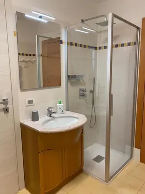 a bathroom with a sink and a toilet and a window at Al Tiglio Rooms in La Valle