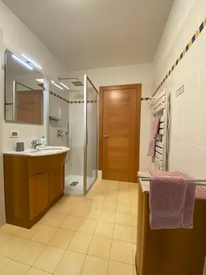 a bathroom with two sinks and a toilet and a window at Al Tiglio Rooms in La Valle