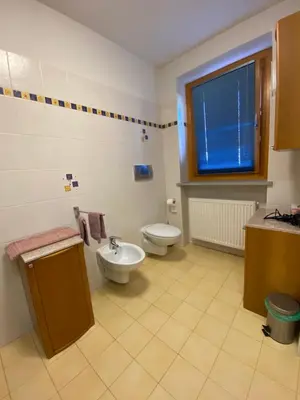a room with two beds and a desk with a television at Al Tiglio Rooms in La Valle