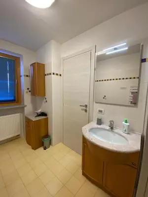a small kitchen with a table and a microwave at Al Tiglio Rooms in La Valle