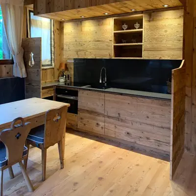 a kitchen with a sink and a table with chairs at Piccolo gioiello di montagna in Villanova
