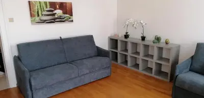 a living room with a couch and two chairs at Casa Rudy in Bolzano