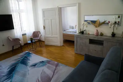 a living room with a couch and a bed at Casa Rudy in Bolzano