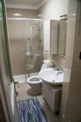a bathroom with a shower and a toilet and a sink at Casa Rudy in Bolzano