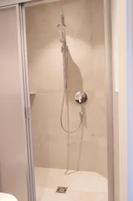 a shower with a glass door in a bathroom at Apartment Weitblick - Alpstay in Naturno
