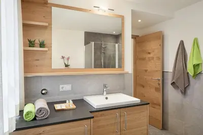 a bathroom with a sink and a mirror at daHoam Appartamenti in Rasùn di Sotto