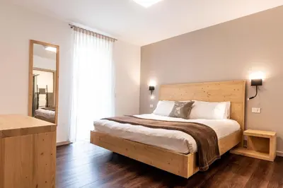 a bedroom with a large bed and a large window at La Pao Bed and Breakfast in Segonzano