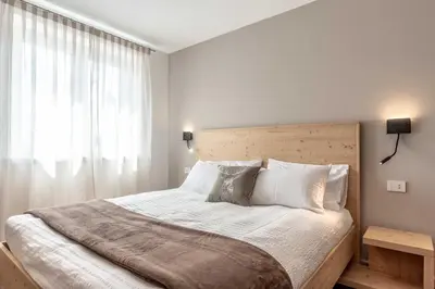 a bedroom with a large bed and a window at La Pao Bed and Breakfast in Segonzano