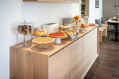 a buffet line with desserts and pastries on it at La Pao Bed and Breakfast in Segonzano