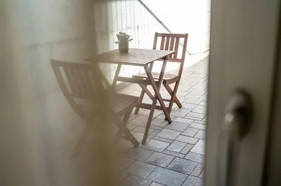 a table with two chairs and a potted plant on it at La Pao Bed and Breakfast in Segonzano