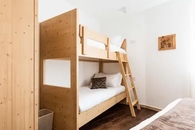 a bunk bed in a room with a ladder at La Pao Bed and Breakfast in Segonzano