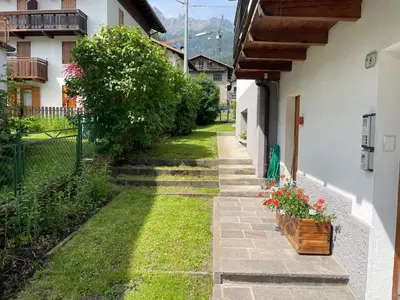 a hallway with a door leading to a yard at SUITE DOLOMITI Appartamento in Falcade