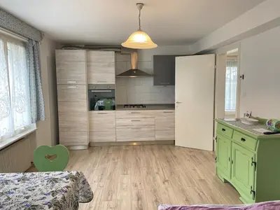 a bedroom with a bed and a table and chairs at SUITE DOLOMITI Appartamento in Falcade