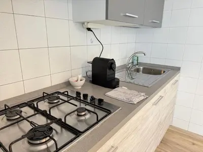 a kitchen with a stove top in a kitchen at SUITE DOLOMITI Appartamento in Falcade