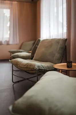 three couches sitting in a room with a window at MyLiving - Hotel B&B by Majestic Resorts Dolomites in San Lorenzo di Sebato
