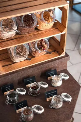 a display of bowls and spoons on a table at MyLiving - Hotel B&B by Majestic Resorts Dolomites in San Lorenzo di Sebato