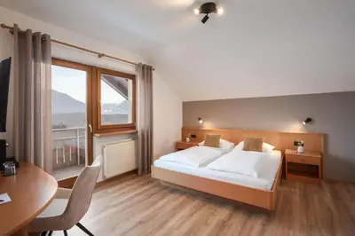 a balcony with a view of mountains at MyLiving - Hotel B&B by Majestic Resorts Dolomites in San Lorenzo di Sebato