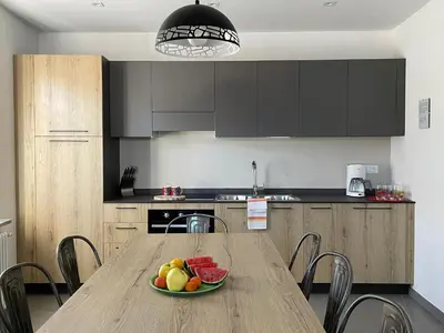 a kitchen with a wooden table with a bowl of fruit on it at RESIDENZA LA CANONICA in Brez