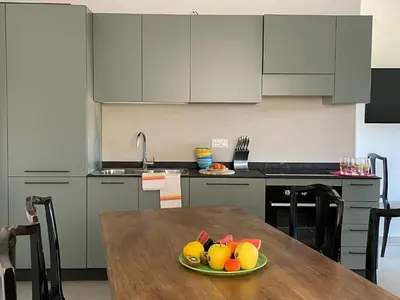 a kitchen with a table with a plate of fruit on it at RESIDENZA LA CANONICA in Brez