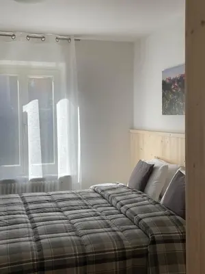a bedroom with a bed and a window at RESIDENZA LA CANONICA in Brez