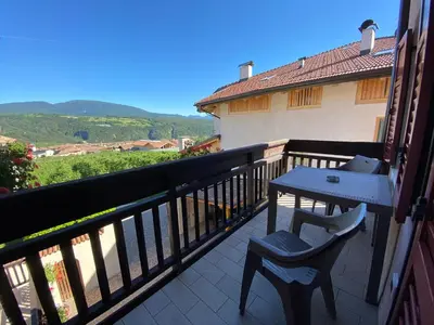 a balcony with a table and chairs and a view at RESIDENZA LA CANONICA in Brez