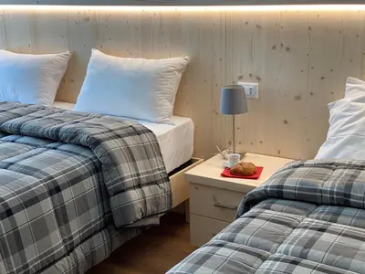 two beds sitting next to each other in a room at RESIDENZA LA CANONICA in Brez
