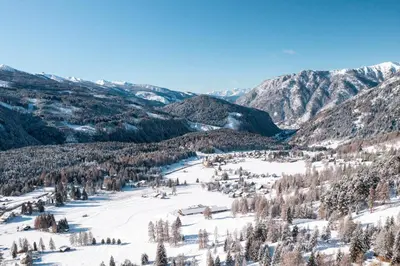 a view of a snowy valley with trees and mountains at Sa Mont Home - Moderno appartamento con parcheggio, sauna e deposito sci in Bellamonte
