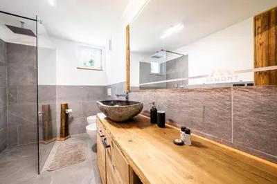 a bathroom with a sink and a glass shower at Sa Mont Home - Moderno appartamento con parcheggio, sauna e deposito sci in Bellamonte