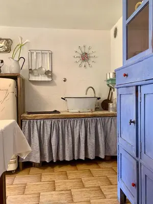 a room with a table with a clock on the wall at Casa Curti in Gosaldo