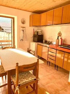 a kitchen with a table and a counter top at Casa Curti in Gosaldo