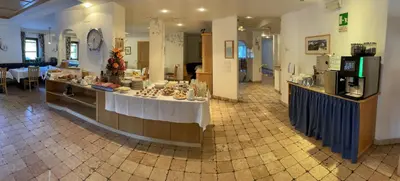 a room with a table with food on it at Pension Angelo in Corvara in Badia