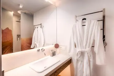 a bathroom with two sinks and a large mirror at Bellevue Bruneck - Suites & Lofts in Brunico