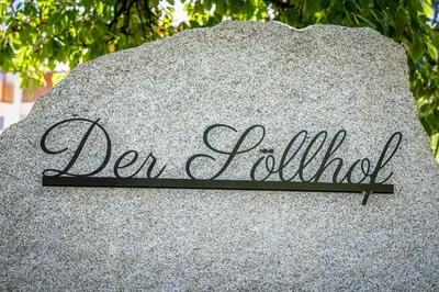 a sign on a rock that reads denilli at Der Söllhof in Bressanone
