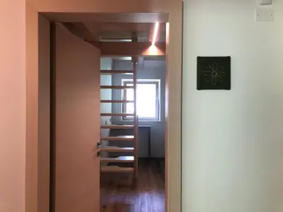 a door leading into a room with a book shelf at B&B Le Stagioni di Stava in Tesero