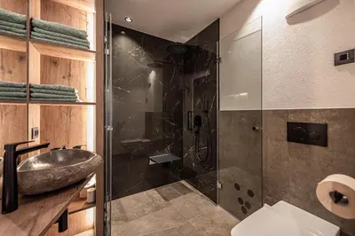 a bathroom with a shower with a sink and a sink at Deluxe Appartement Arve in Valdaora