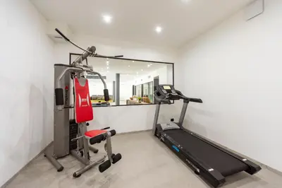 a room with a gym with a treadmill at Active Alm Hotel in Moena