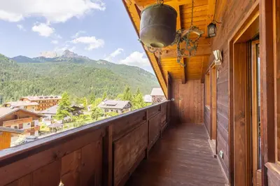 a balcony with a view of the mountains at Mansarda Belvedere - panoramica e wellness in San Vito di Cadore