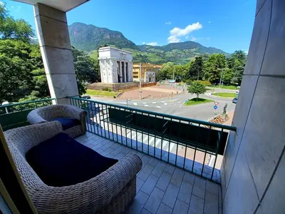 a balcony with two chairs and a view of a street at Alps Apartments Viktory in Bolzano
