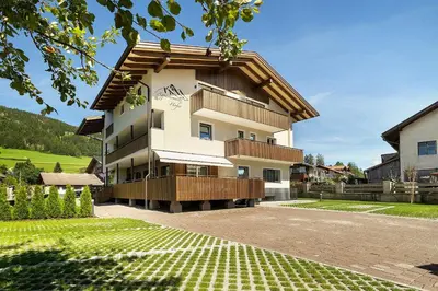 a building with a balcony on the side of it at Premium App Hofer Maria in Villabassa