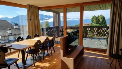 a room with a table and chairs and a large window at Mountain Lodge Margit in Maranza