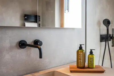 two yellow bottles sitting on a counter next to a sink at Mountain Lodge Margit in Maranza
