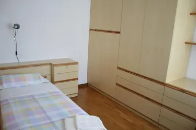 a small bedroom with a bed and a dresser at le stanze di Saraswati in Salorno sulla Strada del Vino