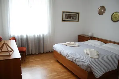 a bedroom with a bed with two towels on it at le stanze di Saraswati in Salorno sulla Strada del Vino