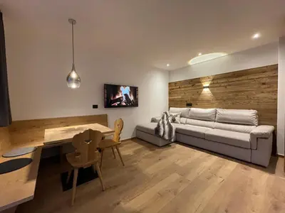 a living room with a couch and a table at Apartments Rainer - Val Gardena in Ortisei